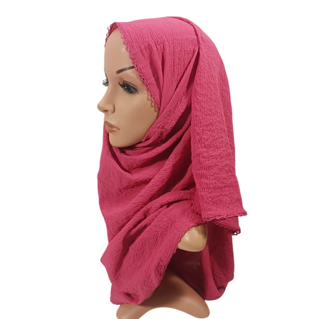 A vibrant Cerise Pink Bubble Chiffon Hijab Scarf featuring a unique textured bubble weave and a delicate matching crochet lace border along the edges.