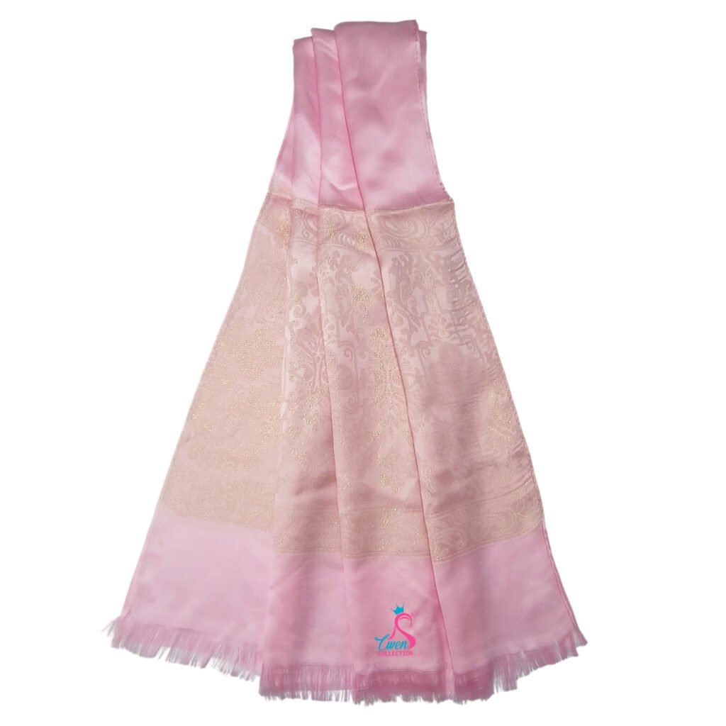 A soft pink Cotton Shimmer Hijab Scarf featuring an elegant woven floral pattern and a delicate fringe edge.