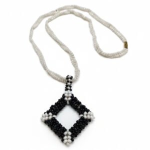 Handcrafted Midnight Frame Beaded Necklace featuring a black and white geometric diamond pendant on a white seed bead chain with a gold clasp.