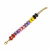 Color Cascade Bracelet featuring a vibrant row of red, purple, pink, yellow, and black faceted beads handwoven with bronze seed beads on a white background.