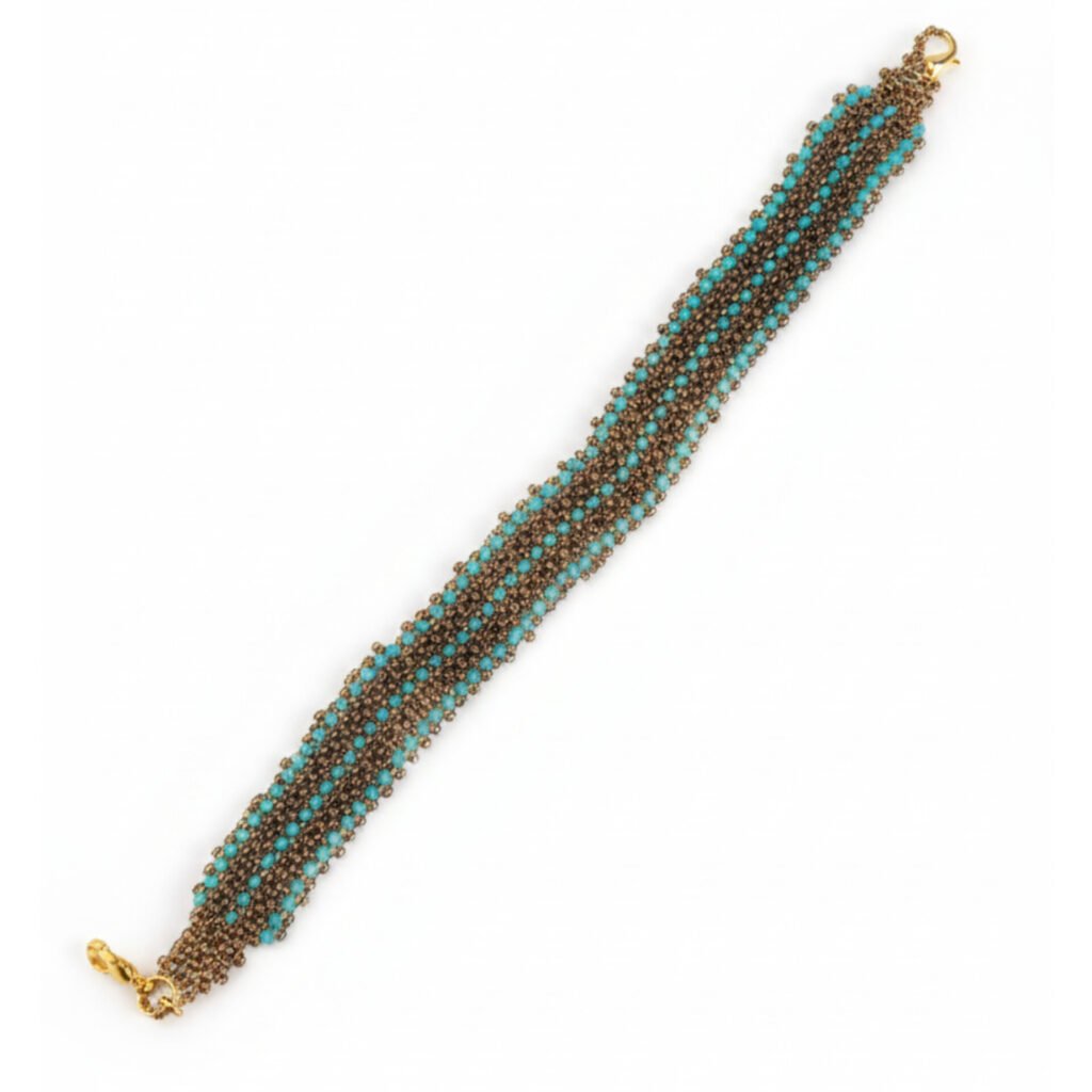 Close-up of the Aqua Gold handcrafted beaded bracelet with a woven aqua and gold seed bead pattern on a white background.