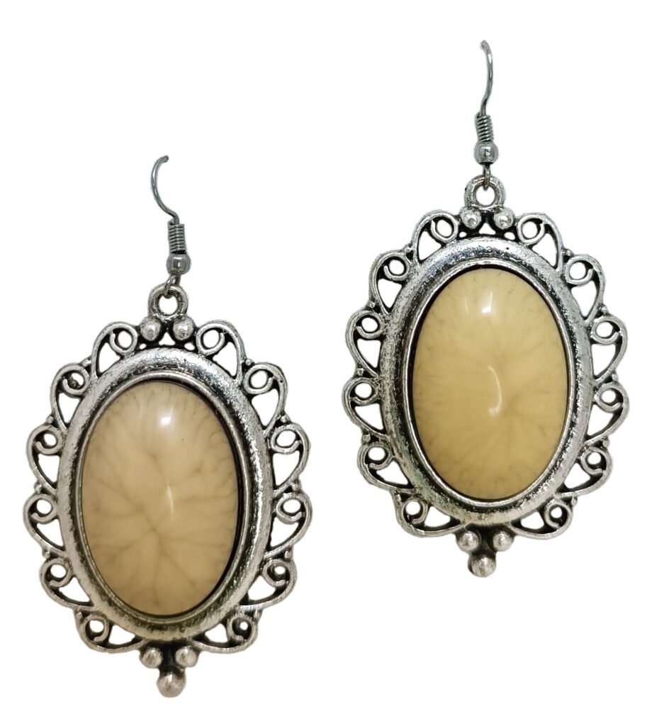 Vintage Oval Dangle Earrings featuring intricate antique silver-toned filigree and a smooth cream-colored center inlay on a white background.