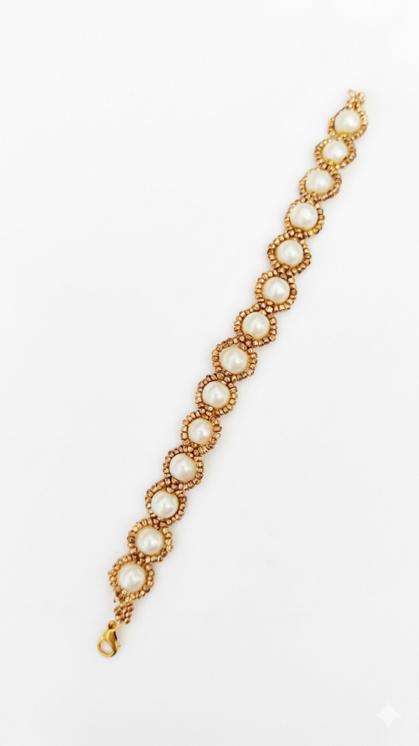 Golden Halo Pearl A handcrafted Golden Halo Pearl bracelet featuring ivory pearls surrounded by gold-toned bead halos with a lobster clasp on a white background.