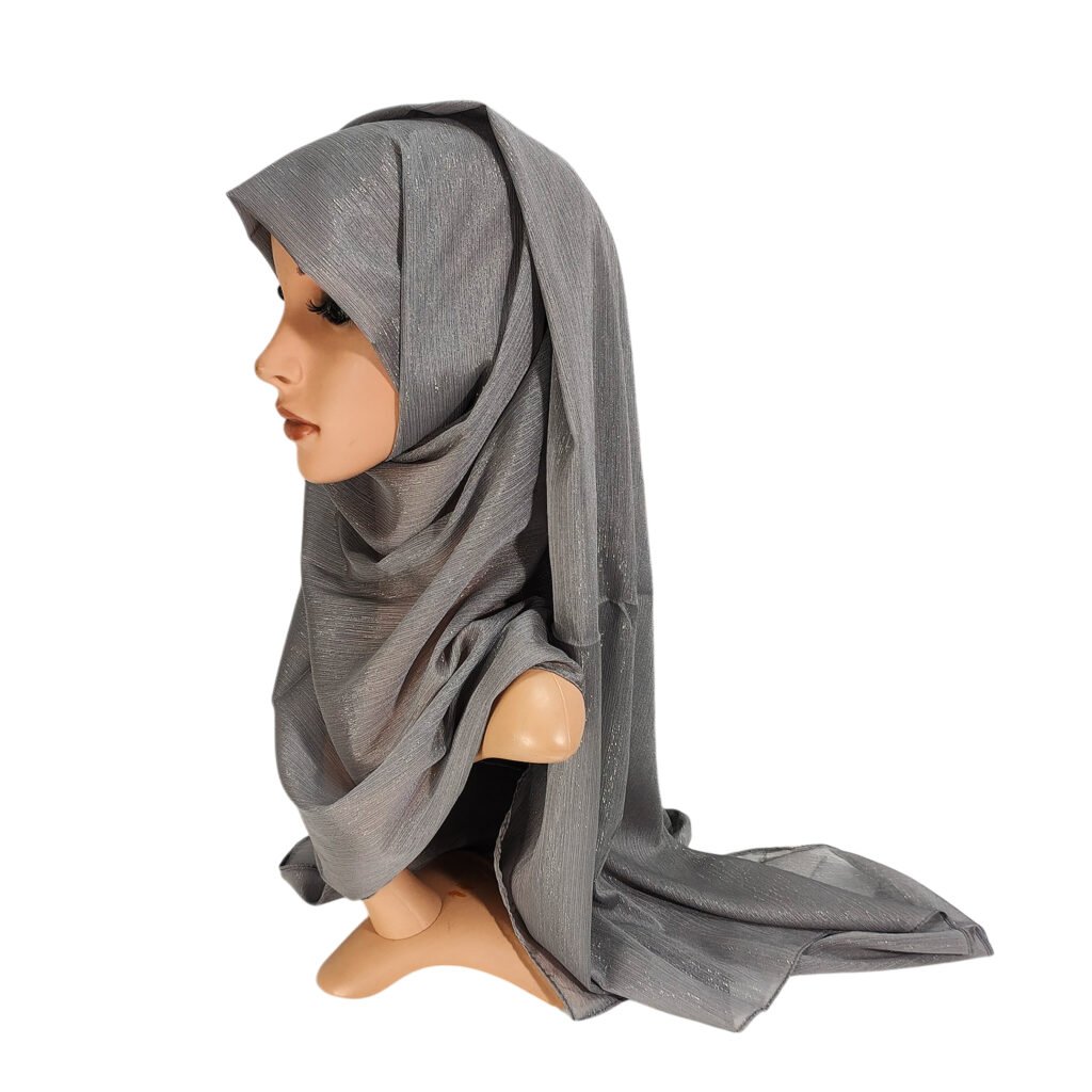 A side profile of a mannequin wearing a dark grey Heavy Chiffon Shimmer Hijab with a subtle metallic sparkle and elegant drapes.