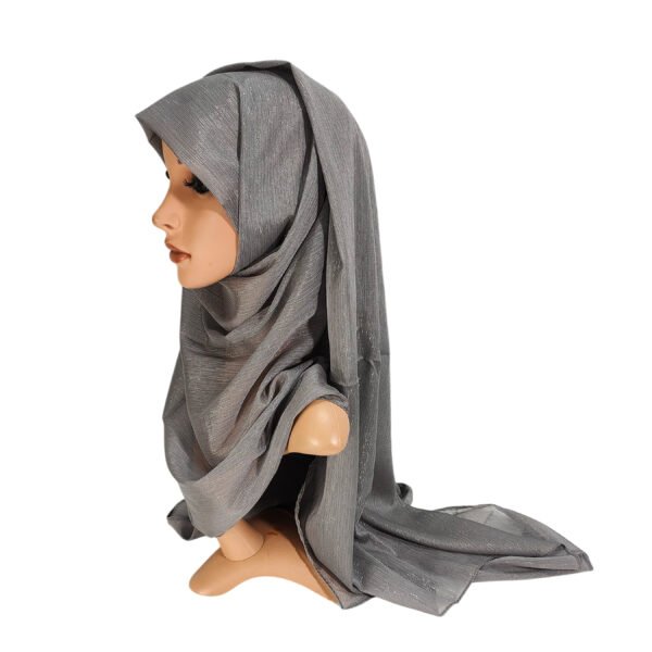 A side profile of a mannequin wearing a dark grey Heavy Chiffon Shimmer Hijab with a subtle metallic sparkle and elegant drapes.