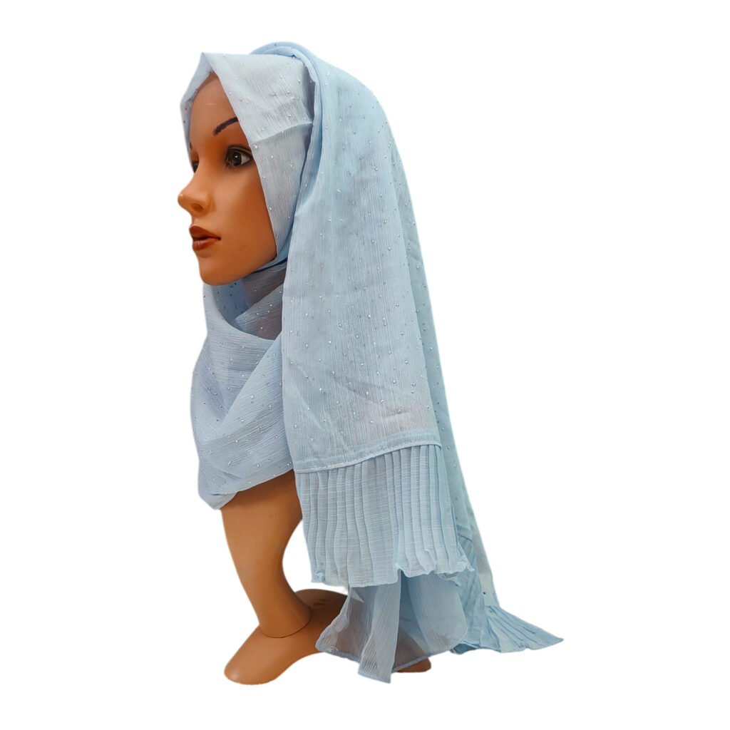 Powder blue ruffled evening wrap hijab made from metallic shimmer chiffon fabric, decorated with sparkly rhinestone accents and a cascading frilled pleated hemline.