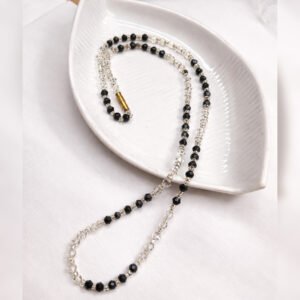 Handmade Classic Noir Necklace by Beads By Nasreen viewed from above on a white leaf-shaped ceramic tray.